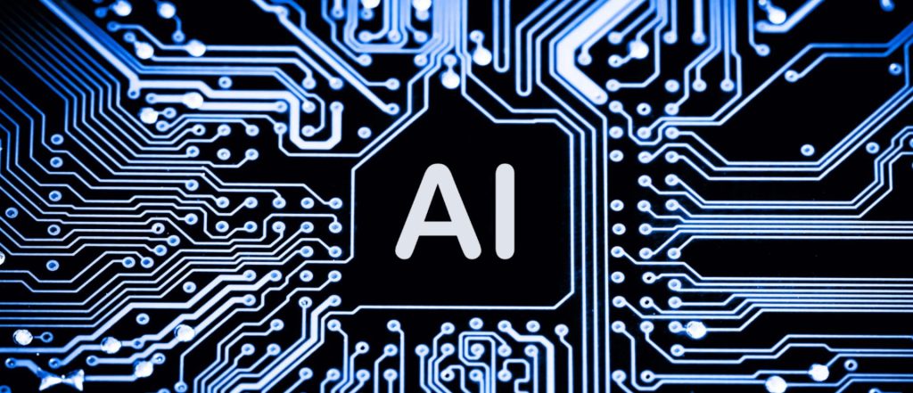 Chip de inteligencia artificial con la inscripción "AI" en el centro, rodeado de circuitos electrónicos iluminados en azul sobre fondo negro.